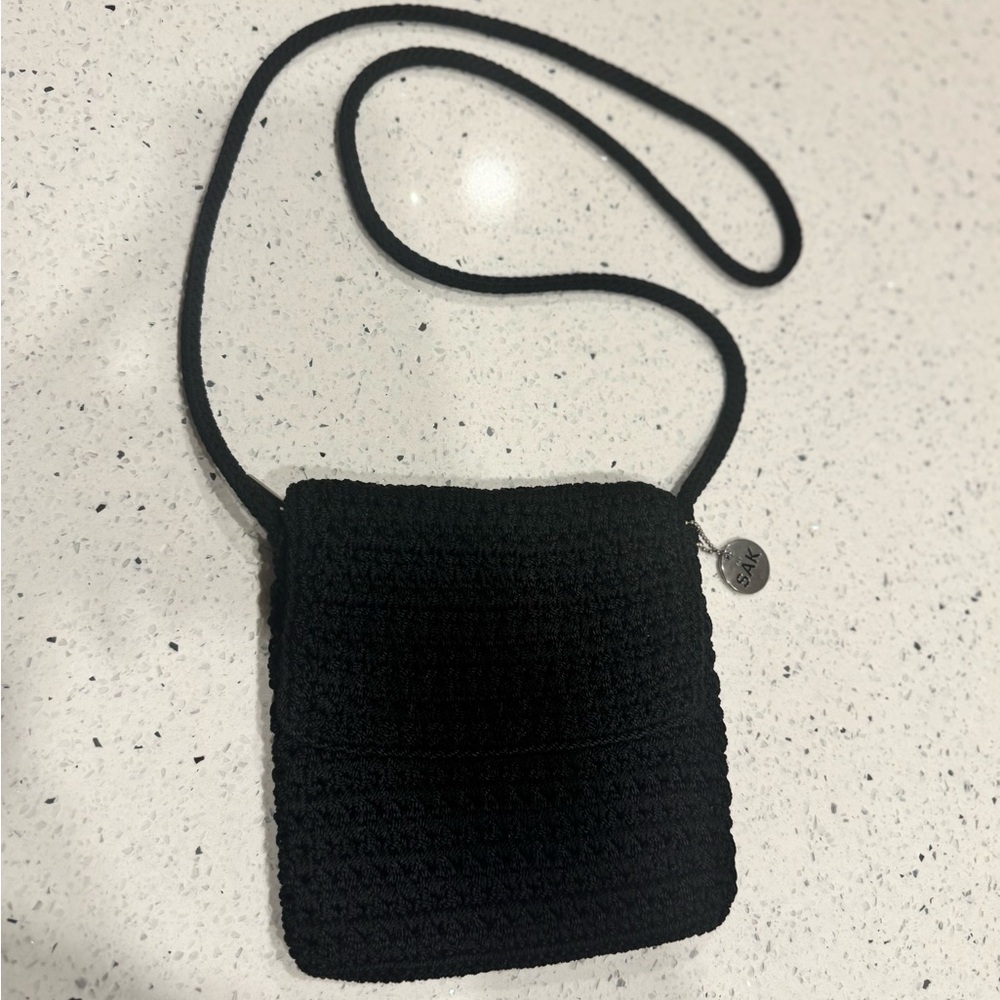 The Sak Black Crocheted Crossbody with Logo Charm